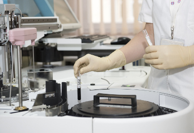 Person holding test tubes