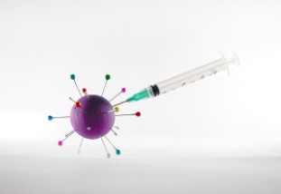 White and green syringe on white surface