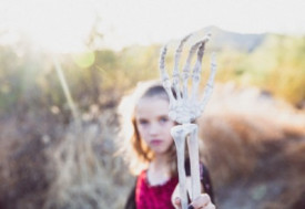 Girl holding white hand skeleton